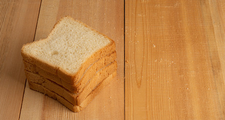 Obraz na płótnie Canvas Slices of bread on wooden table.