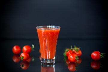 homemade tomato juice in a glass and fresh tomatoes