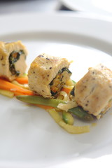 Roasted and sliced chicken fillet stuffed with carrots and pumpkins garnished with vegetables and jamaica sauce.