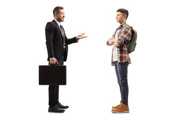 Businessman with a briefcase talking to a male student