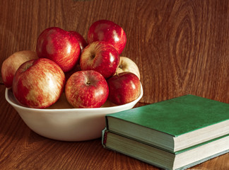 Vase with apples and books