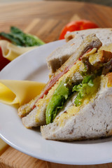 A sandwich club, also called a clubhouse sandwich, is a sandwich of bread, sliced ​​cooked poultry, or fried bacon, lettuce, tomato, and mayonnaise.