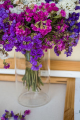 A bouquet of field purple flowers in a glass flask. Vase. Still life. White background.