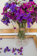 A bouquet of field purple flowers in a glass flask. Vase. Still life. White background.