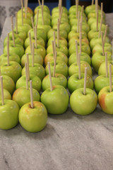 ripe green apples with a stick ready for caramel coating and nuts 