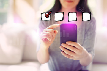 Checklist with woman using her smartphone in a living room