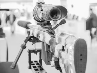 Fototapeta na wymiar Rifle with a telescopic sight and stand
