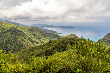 Panoramic view at the landscape on Seychelles island Mahé with clear blue water and green mountains