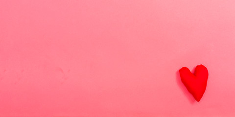 Valentine's day heart shaped pillow on a pink paper background