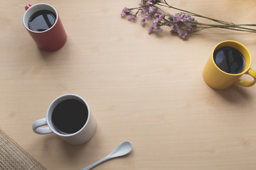 Three coffee cup  on the wooden table and space in the middle