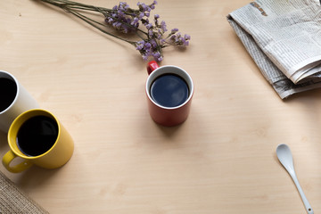 Three coffee cup on the table with newspaper