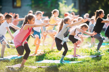 Obraz premium Yoga classes outside on the open air. Kids Yoga,