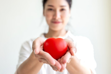 Asian woman holding a red heart