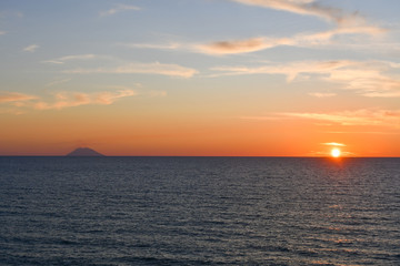 Spectacular sunset over the sea next to the Stromboli volcano