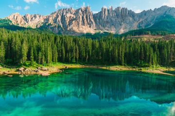 Beautiful turquoise Alpine lake Carezza or Lago di Carezza in Dolomites mountains, South Tyrol, Italy