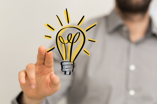  holding illuminated light bulb, idea, innovation and inspiration concept.
