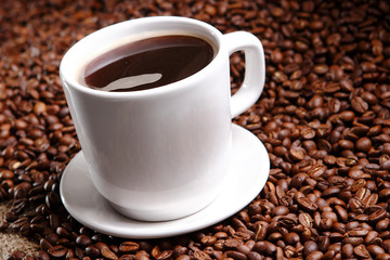 Coffee with grains and sweet bread. Coffee is a brewed drink prepared from roasted coffee beans, the seeds of berries from certain Coffea species.