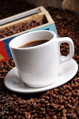 Coffee with grains and sweet bread. Coffee is a brewed drink prepared from roasted coffee beans, the seeds of berries from certain Coffea species.