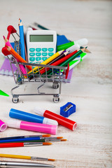 Items for school in a shopping cart.