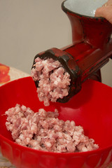Meat grinder - process of grinding meat. Beef mince in mincing-machine. Cooking food