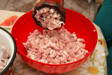 Meat grinder - process of grinding meat. Beef mince in mincing-machine. Cooking food