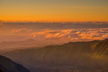 The beautiful sunrise at Mount Bromo volcano, the magnificent view of Mt. Bromo located in Bromo Tengger Semeru National Park, East Java, Indonesia.Image contains noise grain and blurry.