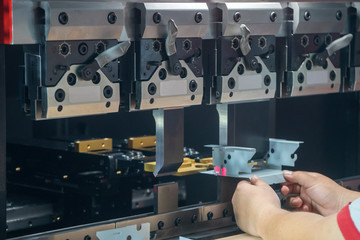The hydraulic bending machine operation by technical operator. The sheet metal manufacturing...