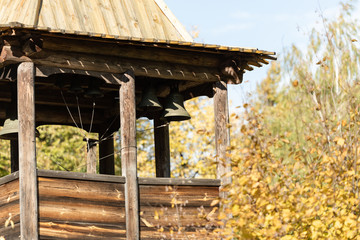Chapel near the Butovo burial. Wooden Church with bell tower and bells. Orthodox chapel in autumn.