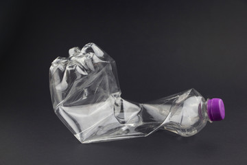 Old plastic bottle on a black background