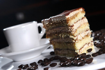 Dessert of chocolate, vanilla and walnut accompanied by a cup of espresso coffee.