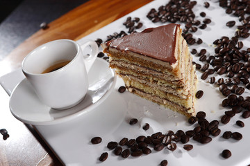 Dessert of chocolate, vanilla and walnut accompanied by a cup of espresso coffee.