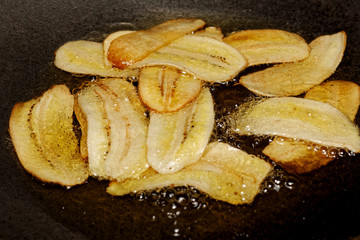Fried banana slice with vegetable oil in pan