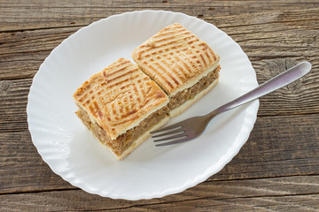 Apple pie two slices of cake on plate at wooden table