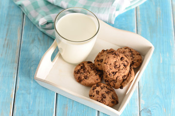 Milk and cookies on the white tray. Biscuit on the turquoise table