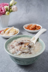 A bowl of shiitake mushroom lean porridge and sour cabbage sour radish