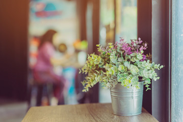 Artificial plants or plastic tree on table for decoration and welcome for customers in coffee shop.