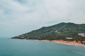 Green ocean shore and beach in Hainan island, China.
