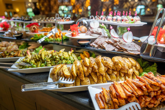 Close up of foods with plates in buffet of restaurant.