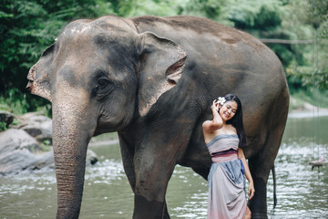 Fototapeta premium Portrait Asian woman enjoying with elephant 