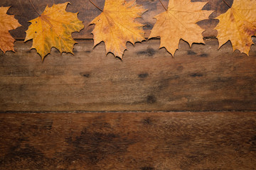 Naklejka na ściany i meble Autumn leaves on rustic wooden background. Top view with copy space.