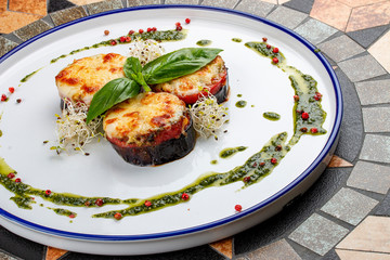 Eggplant with tomatoes, pesto and mozzarella cheese. Italian dish