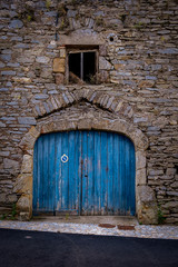 Blue barn doors on stone french facade #1