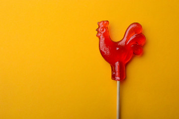 Sugar cockerel on a wood stick. © Mikhail