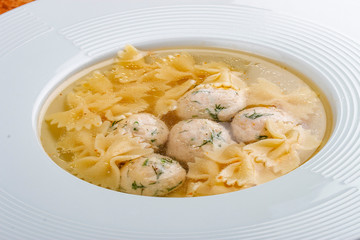 Chicken broth with meatballs and farfallina