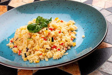Couscous with vegetables in a ceramic decorative plate
