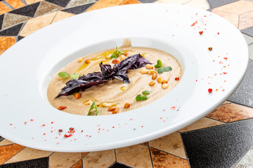 Cream soup of porcini mushrooms with pine nuts