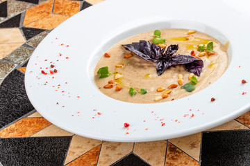 Cream soup of porcini mushrooms with pine nuts