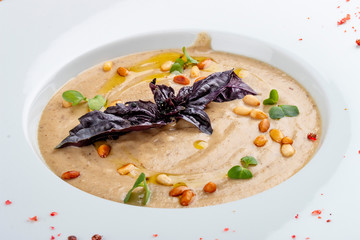 Cream soup of porcini mushrooms with pine nuts