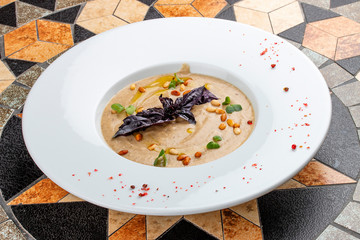 Cream soup of porcini mushrooms with pine nuts
