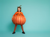 little girl in pumpkin costume